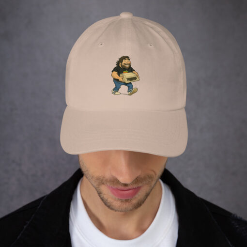 From the garage in Cupertino to your closet. This exclusive Steve Wozniak dad hat celebrates the genius who helped shape computing history—carrying his legendary Apple II in bold comic art style.